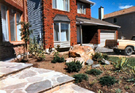 This newly built home has Flagstone steps curving up from the driveway